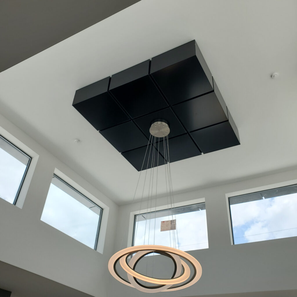 Black ACP ceiling panels with modern pendant lighting