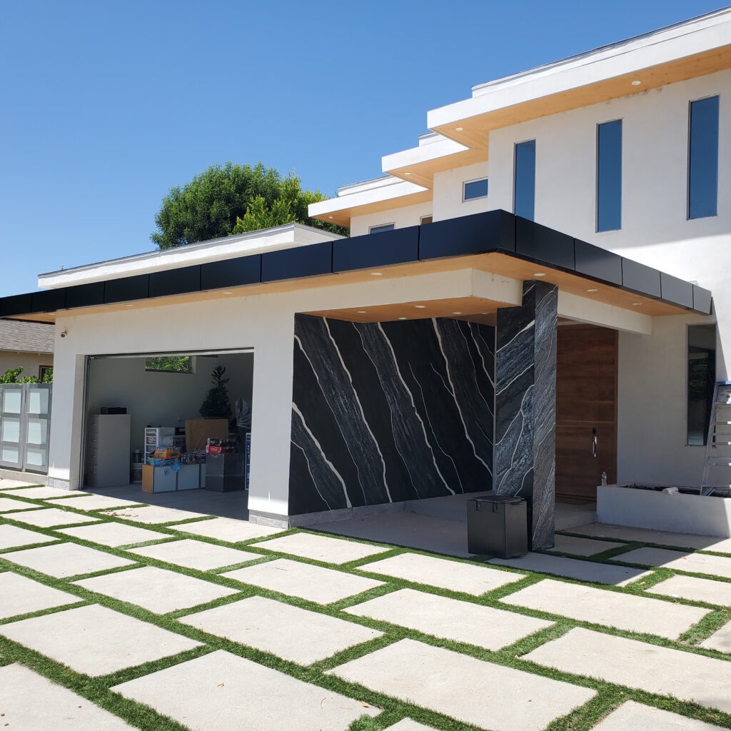 Black ACP canopy with aluminum composite panel cladding on a modern house