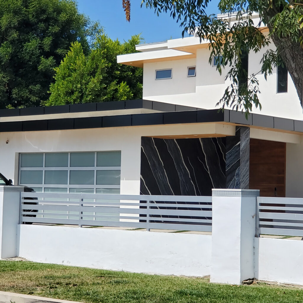 Black ACP canopy with aluminum composite panel cladding on a modern residential facade