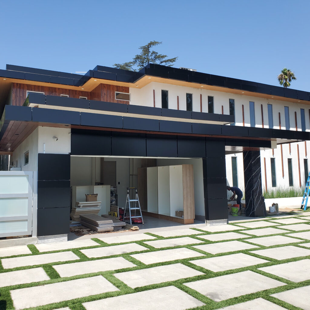 Black ACP canopy and aluminum composite panel cladding on modern residential facade