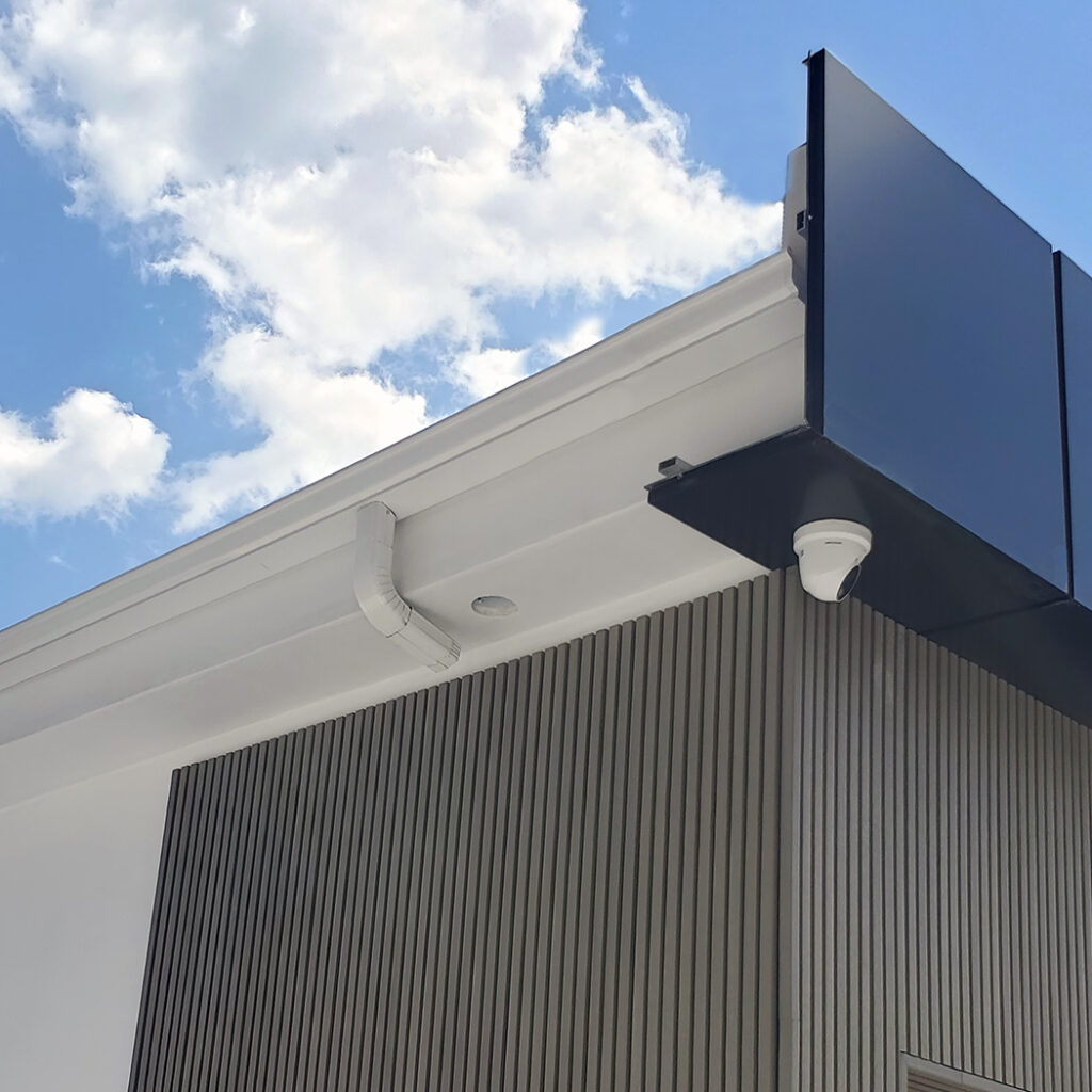 Image: ACP gutter guard installed on a commercial building, providing effective protection and durability for the structure.