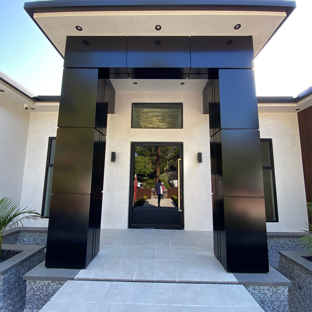 Modern residential entrance with black ACP column cladding.