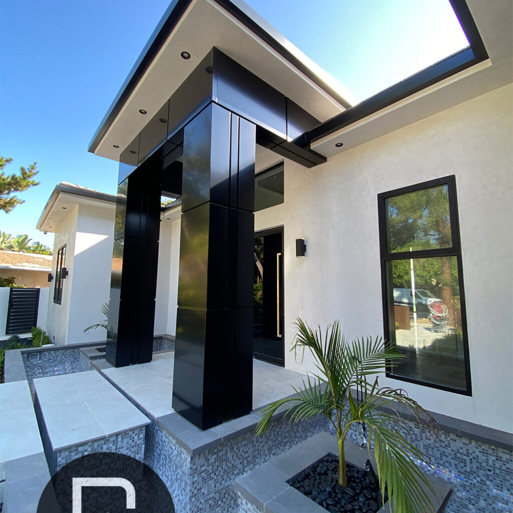 Black ACP columns at the entrance of a modern residential home with sleek design.