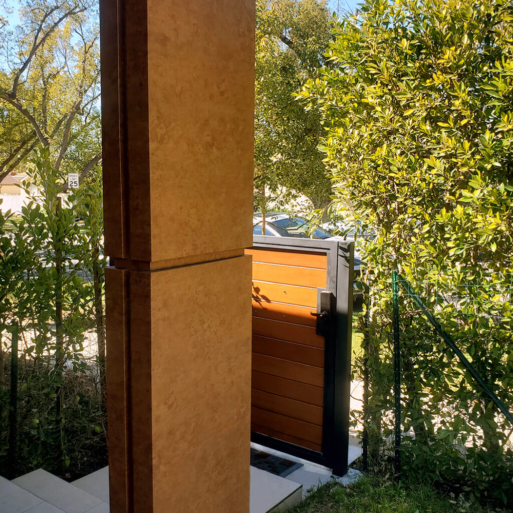 Modern residential entrance with black ACP panels covering the columns.