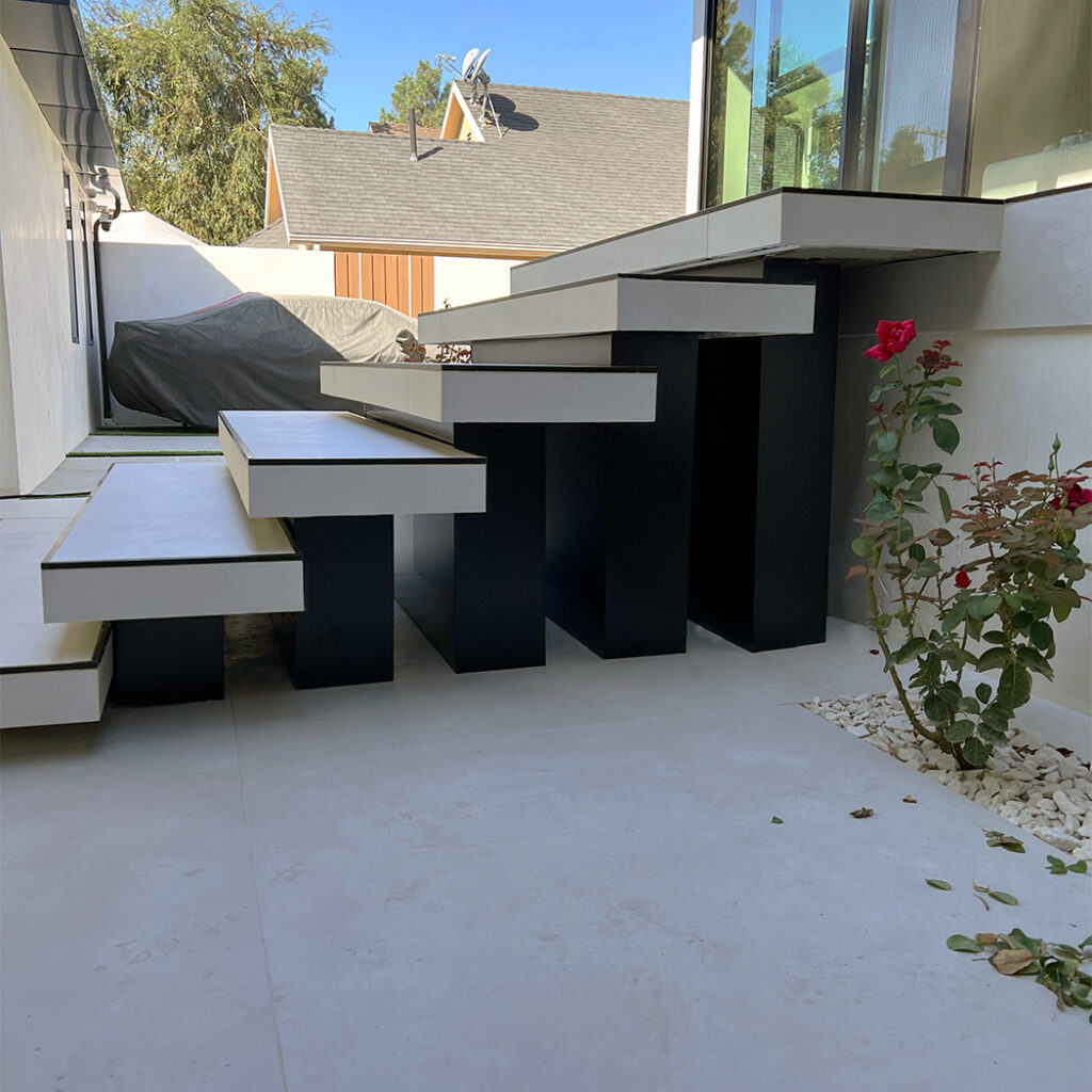 Luxury home entrance with bold black ACP architectural columns.