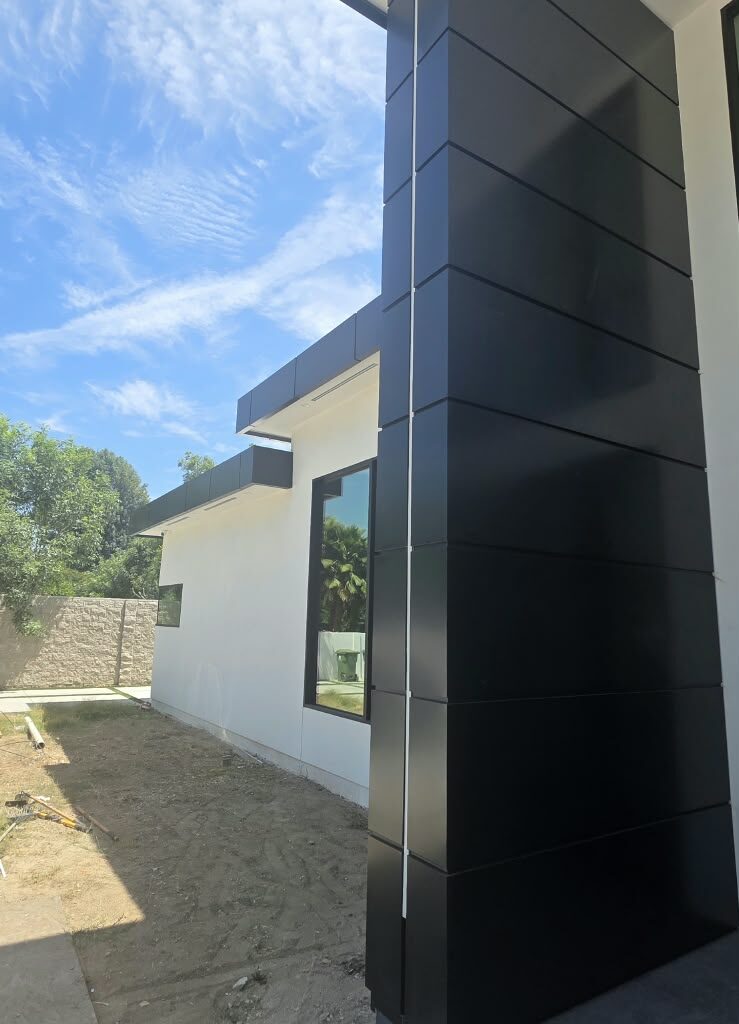 ACP column cladding on modern home entrance with black aluminum composite panels